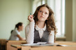 © Evgeny Sumin - schoolgirl eager to answer a question,Girl holding pencil looking up