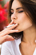 © IVASHstudio - Brunette woman smokes a cigar