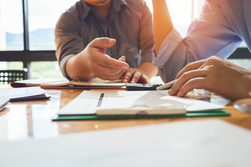 Business colleagues are meeting to determine their duties to summarize annual performance in the company's meeting room. The documents, business contracts placed on a wooden table.