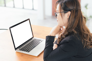 Wall Mural - Asian young business freelance woman happiness working online business with Blank screen laptop in cafe shop. Working concept, in selective focus.