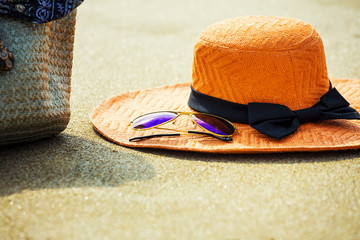 Hat, sunglasses and bag with on tropical beach