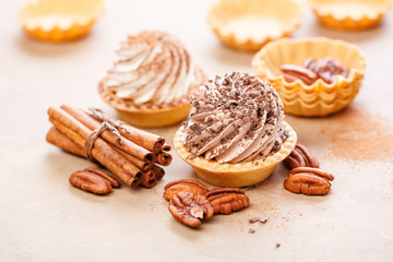 Sweet tarts with whipped cream and pecans, selective focus.