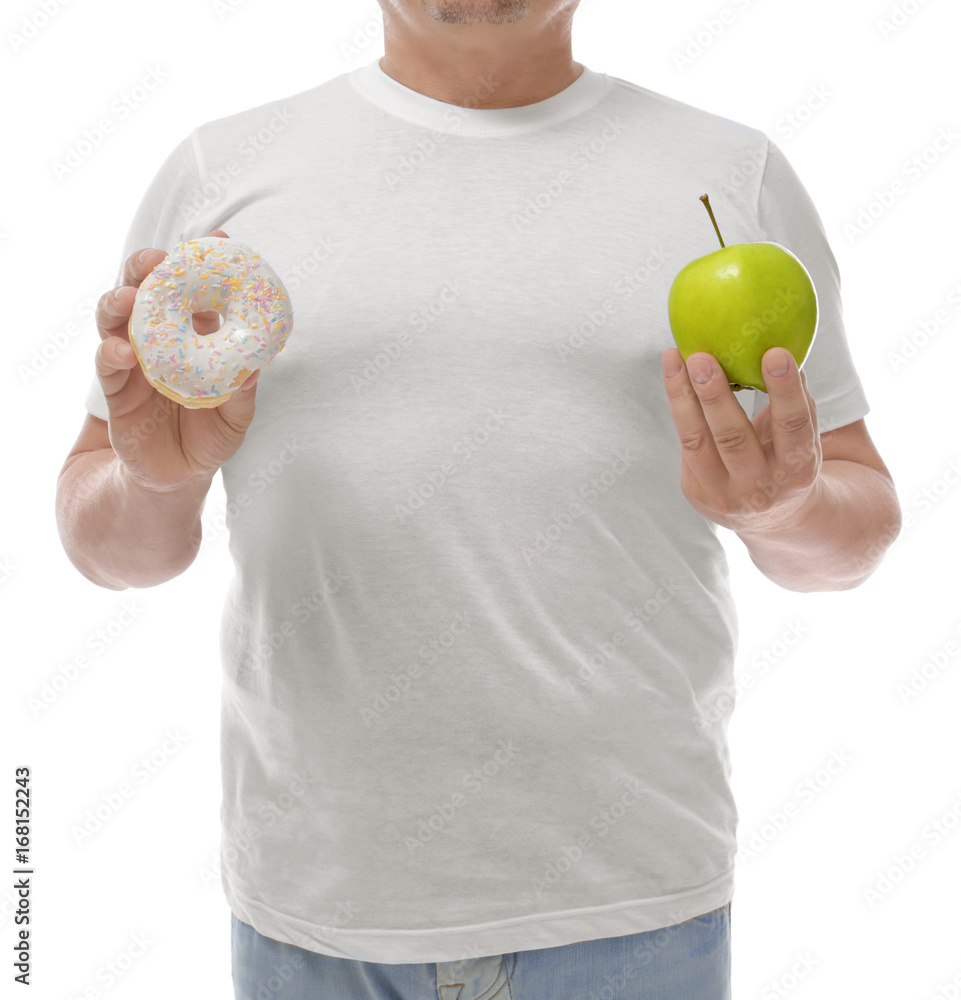 Overweight man with apple and donut on white background. Diet concept