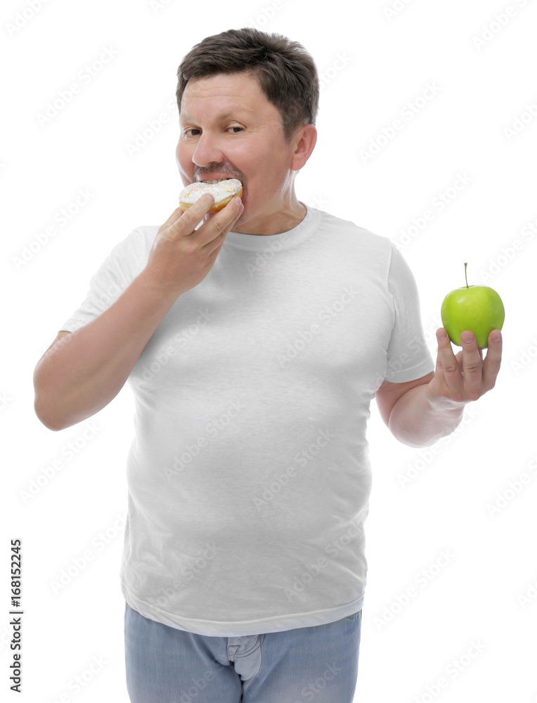 Overweight man with apple and donut on white background. Diet concept