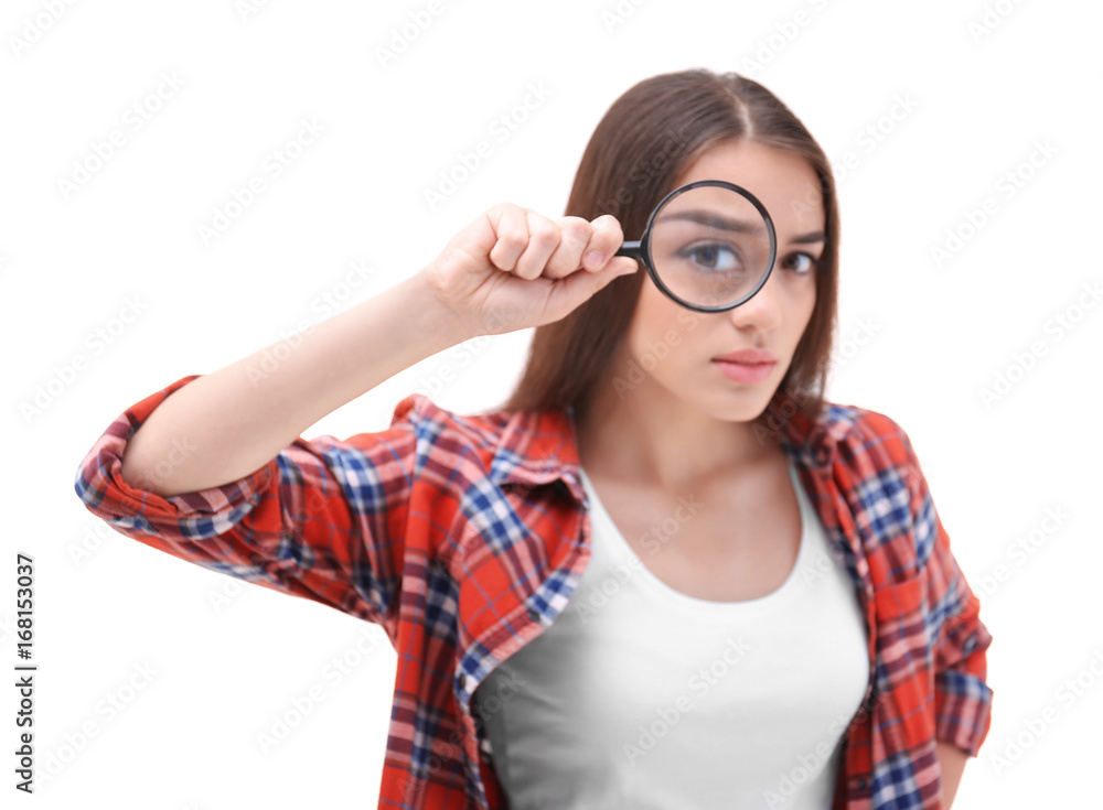 Beautiful young woman with magnifier on white background