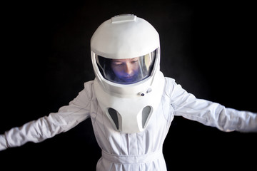 Wall Mural - Astronaut in a helmet looks down. Fantastic space suit. Exploration of outer space.