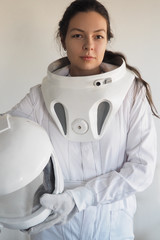 Wall Mural - Female astronaut on a white background. Fantastic space suit. Exploration of outer space.