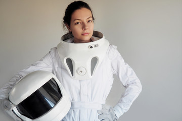 Wall Mural - Female astronaut on a white background. Fantastic space suit. Exploration of outer space.