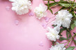 White peonies with decorative hearts on a pink background.