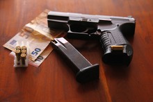 9mm Pistol On A Desk With Money And A Loaded Magazine