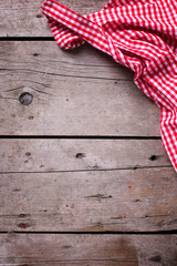 Canvas Print - Red and white kitchen towel on rustic wooden background.