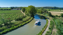 Aerial Top View Of Boat In Canal Du Midi From Above, Family Travel By Barge And Vacation In Southern France
