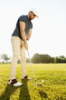 Male golfer about to tee off a golf ball