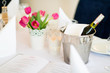 Stół w restauracji z wiaderkiem lodu i winem oraz karta dań menu i dekoracja z tulipanów 