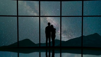 Wall Mural - The couple stand near a window against the meteor shower in the sky. time lapse