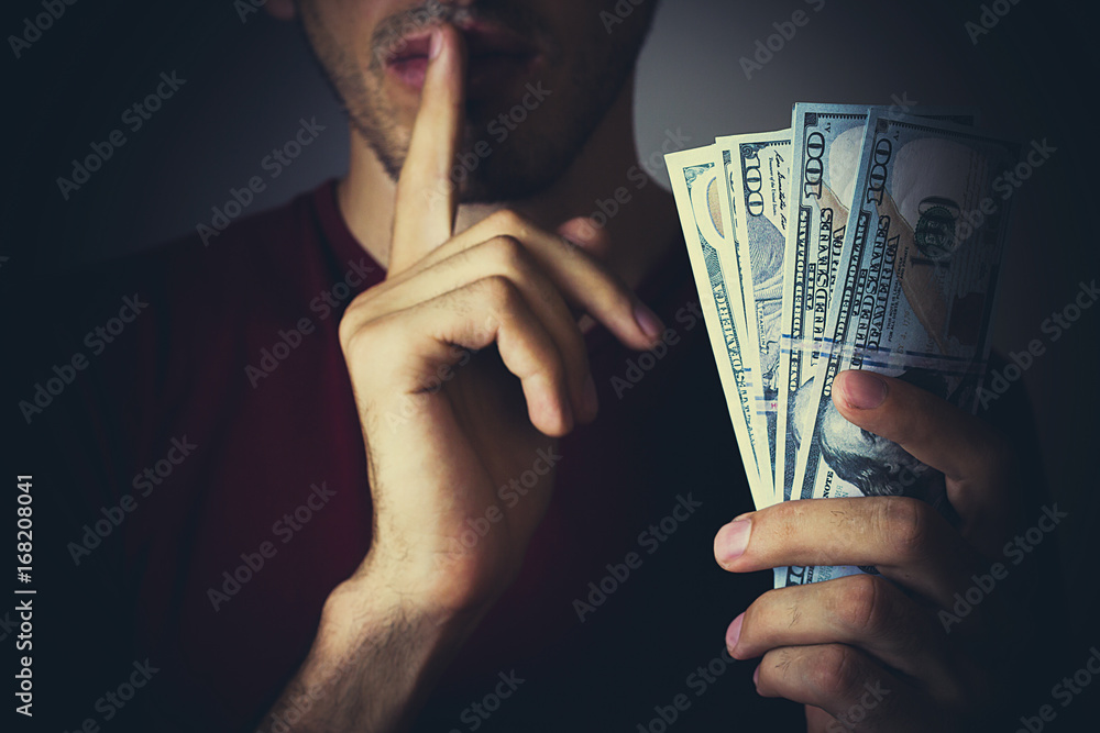 Bribery people with dollar bills in hand and quiet gesture
