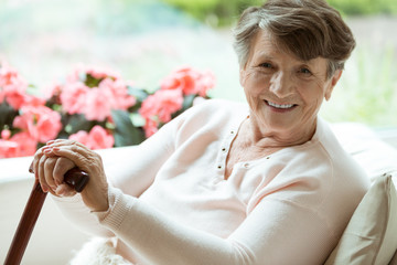 Woman with walking stick smiling