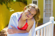 © Marc Romanelli/Blend Images - Wet Caucasian girl leaning on railing