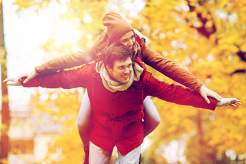 happy young couple having fun in autumn park