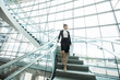 © Mike Kemp/Blend Images - Pensive Mixed Race businesswoman descending staircase