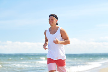 Wall Mural - happy man running along summer beach