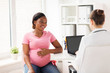 © Syda Productions - doctor with laptop and pregnant woman at clinic