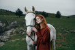 © SHOTPRIME STUDIO - Woman is walking with a white horse in the mountains in nature