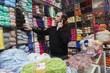 © REB Images/Blend Images - Mixed Race man talking on cell phone at yarn store