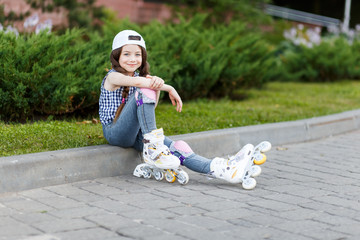 Little girl rollerskating in park