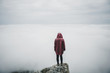 © Alexey Karamanov/Blend Images - Woman standing on rock and looking at fog