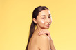 © SHOTPRIME STUDIO - Young beautiful woman on a yellow background, cosmetic cream, beauty, skin care