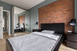Modern bedroom with brick wall