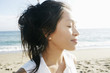 © Peathegee Inc/Blend Images - Portrait of Vietnamese woman at beach with eyes closed