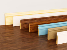 Baseboards With Various Profiles Standing On Hardwood Surface. 3D Illustration
