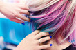 Hands in rainbow hair