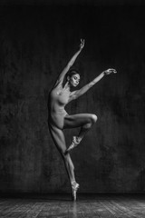 Young beautiful dancer is posing in studio