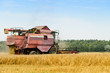 © smspsy - Agriculture machine harvesting golden ripe wheat in field for grain export. Agriculture and farming concept