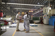 © Blue Jean Images - Confident engineers talking in the factory