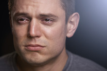 Close Up Portrait Of Crying Young White Man Looking Away