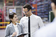 © Blue Jean Images - Businessman and businesswoman talking in the factory