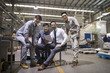© Blue Jean Images - Portrait of businessman and engineers in the factory