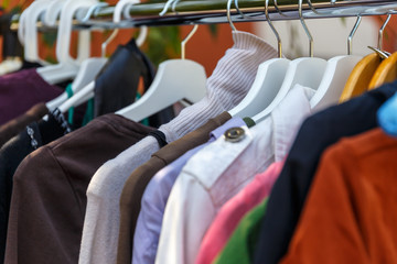 Wall Mural - Hangers with men's and women's clothing at the garage sale