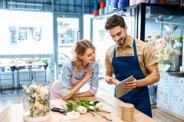 florists with digital tablet in flower shop