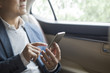 © Blue Jean Images - Businessman using smart phone inside car