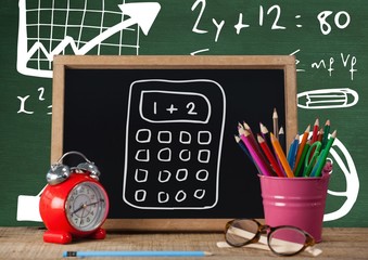 Canvas Print - Desk foreground with blackboard graphics of calculator and formu