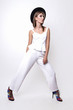 © yuliachupina - Girl in a white suit and black hat in the studio on a white background.