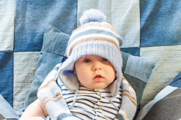 Wall Mural - portret funny baby boy in a warm hat