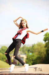 Wall Mural - Beautiful young woman dancing on the street