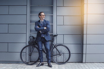 Senior business man with a bicycle outdoors