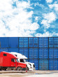© ANGHI - Big trucks on the background of cargo containers. Cargo delivery, logistic, shipping and transportation concept. Blue freight containers on the sky background